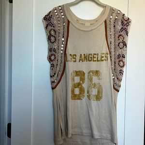 Top with sequin and embroidered detailing on the sleeves.